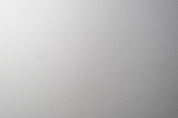 istock Matte gray smooth plastic surface with fine texture and vignette on the right side. Exquisite textured background, soft blank backdrop 1342836702