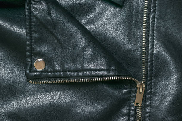 istock The background of an unbuttoned leather jacket with metal rivets. Flat lay. 1342837017