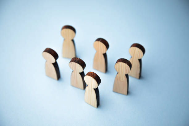 istock Wooden figure standing with team 1342855455
