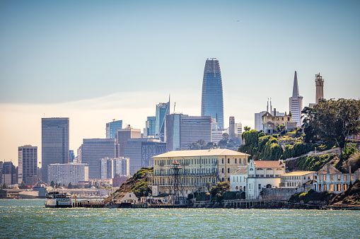 penitentiary of Alcatraz Island harbor with skyline of San Francisco, California, USA.
