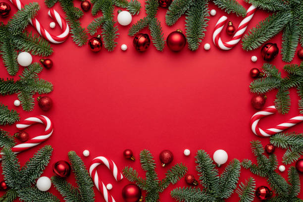 istock Christmas ornaments Frame with fir branches on a red background 1342898894