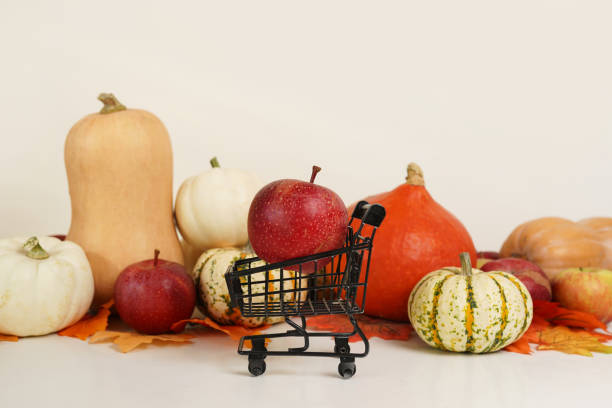 Happy thanksgiving, black Shopping cart with apple and pumpkins on white background Happy thanksgiving, black Shopping cart with apple and pumpkins on white background thanksgiving holiday hours stock pictures, royalty-free photos & images