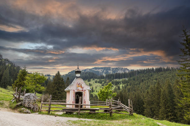 a colorful sunset with a small chapel in the alps of Bavaria