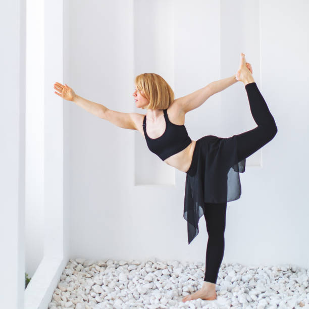 istock Young adult woman practicing yoga 1342903328