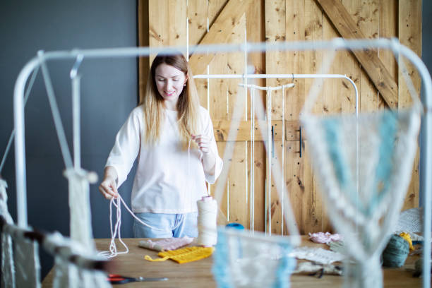 istock Young adult woman teaching macrame online 1342906142