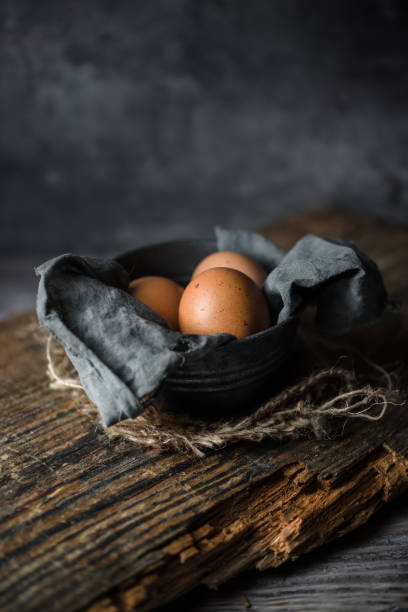 istock Raw eggs in egg box on rustic wooden background 1342928753