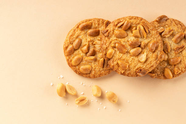 istock Cookies with roasted peanuts on top on beige background. 1342929831