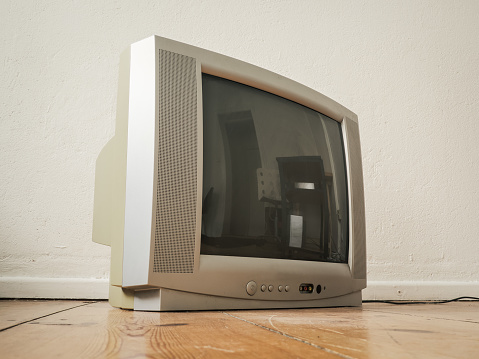 Side view of an old Retro TV on Wooden Ground