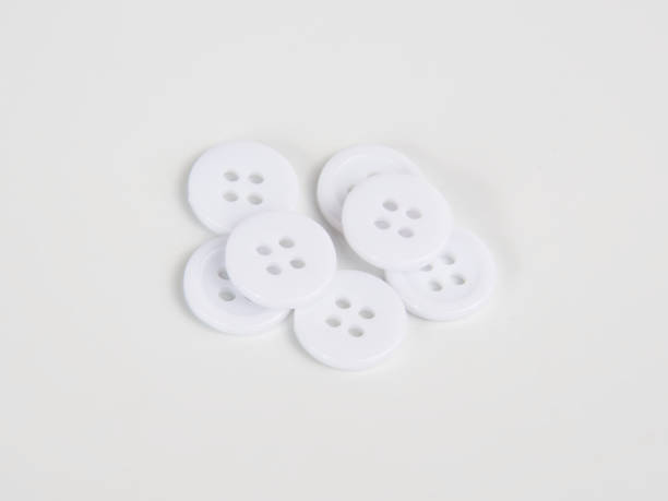 istock White bright cloth buttons on the white background 1342932157
