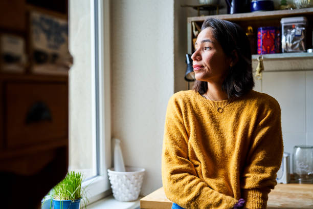 istock Young woman standing in the kitchen and looking away 1342949816