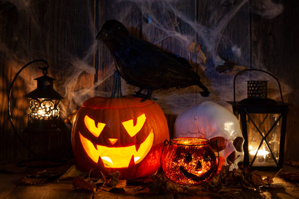 istock Halloween Jack-o-Lantern Pumpkins on rustic wooden background 1342949826