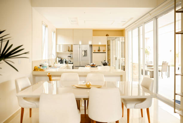 Dining area and kitchen of a contemporary home Interior of the dining area and kitchen of a bright modern home with contemporary furnishings showcase interior dining room home decorating home interior stock pictures, royalty-free photos & images