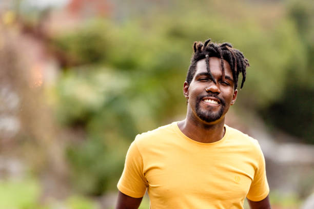 istock Smiling young man standing outside in summer 1342952530