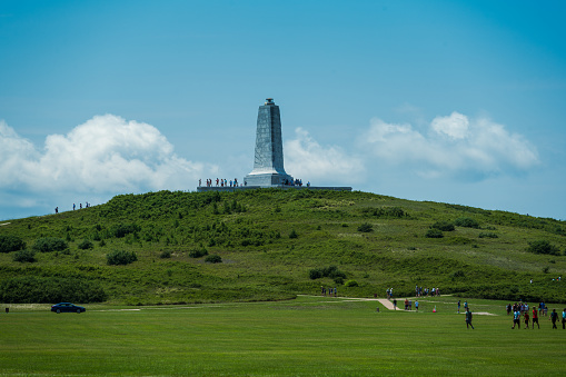Kitty Hawk, NC, USA -- July 27, 2021. Photo of the Kitty Hawk Memorial and crowds gathering at the memorial and on the grounds.