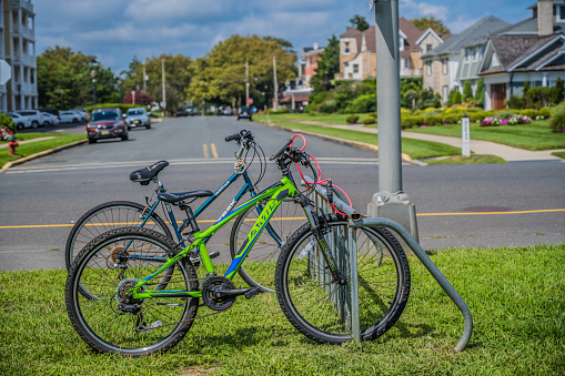 Spring Lake, NJ, USA — August 31, 2021. Two bicycles parked in a rack by Ocean Road in Spring Lake, NJ.