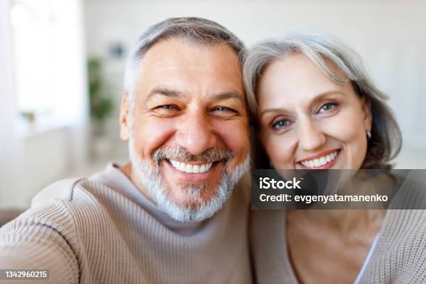 Portrait Of Happy Beautiful Senior Caucasian Couple Smiling At Camera While Making Selfie Stock Photo - Download Image Now