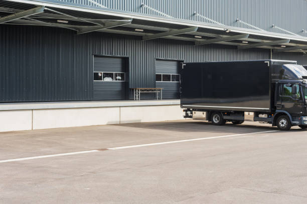 black truck at loading ramps of a warehouse