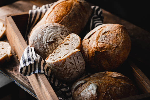 istock Fresh wheat breads in wooden box 1342962580