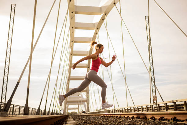 istock Woman with headphones jumping 1342962942