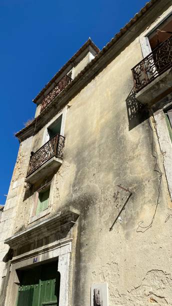 istock Old building windows heritage site outside green door balcony 1342964686