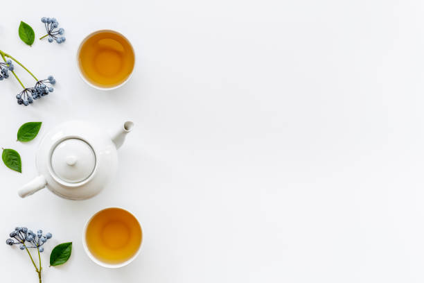 istock Two cups of tea with white teapot, top view 1342978944