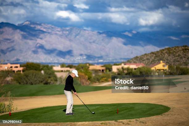 Retired Woman Playing Golf In Tucson Arizona Stock Photo - Download Image Now - Adult, Arizona, Cactus