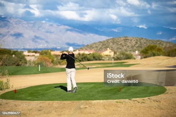Retired Woman Playing Golf In Tucson Arizona Stock Photo - Download Image Now - Adult, Arizona, Exercising