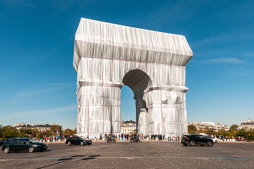 L'Arc de Triomphe, Wrapped, by the artists Christo and Jeanne Claude is a temporary artwork for Paris, on view for 16 days from Saturday, September 18 to Sunday, October 3, 2021. The Arc de Triomphe build by Napoleon, is wrapped in 25,000 square meters of recyclable polypropylene fabric in silvery blue, and with 3,000 meters of red rope. The project has been realized in partnership with the Centre des Monuments Nationaux and in coordination with the City of Paris.    France, Place de l’Etoile / Charles de Gaulle in Paris. September 23, 2021.