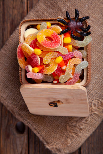 istock Bowl of Halloween Candy Corns on Rustic Wooden Table 1342987179