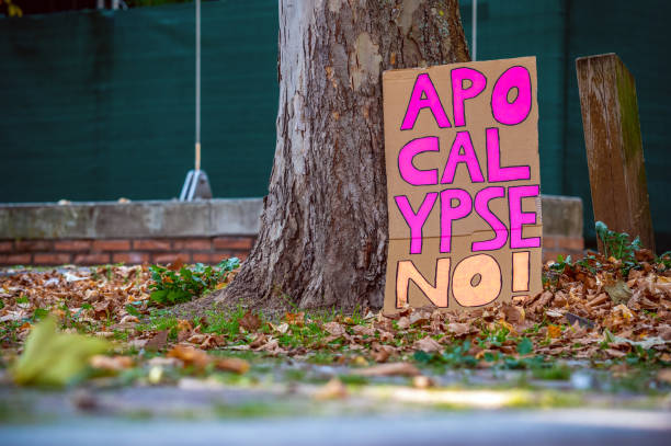 Lost cardboard sign saying "Apocalypse no!" after the Fridays for Future climate protests in Leipzig Self-painted cardboard sign with pink writing climate justice photos stock pictures, royalty-free photos & images