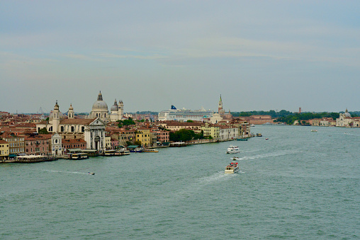 Venice, Italy - May 28, 2023: taxi boats with passangers near to the downtown of  Venice