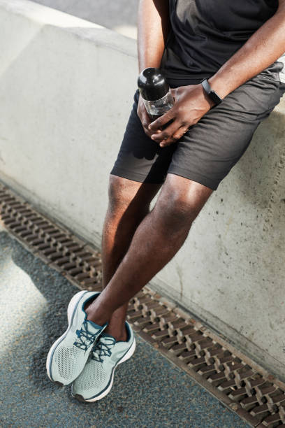 istock Athlete with water standing outdoors 1342999128
