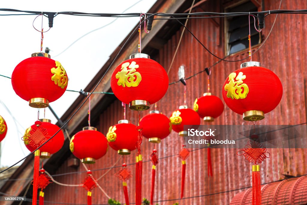 Chinese red lantern Chinese red lantern against a red house  in George town on Penang island, Malaysia Art Stock Photo