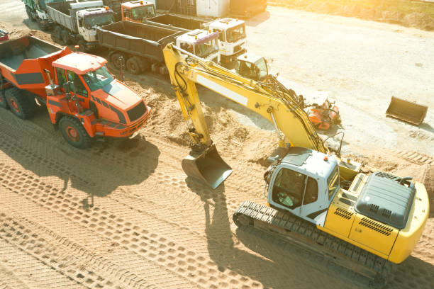 istock Excavator plans land at construction site, excavator digs trenches 1343006655