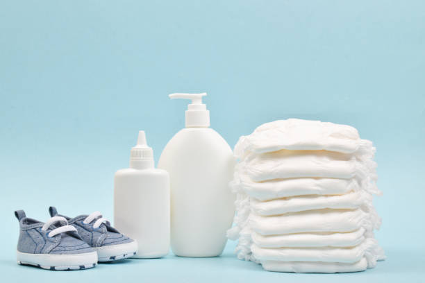 istock Various accessories for children's hygiene. A large stack of diapers next to them are bottles of baby cosmetics. 1343022275