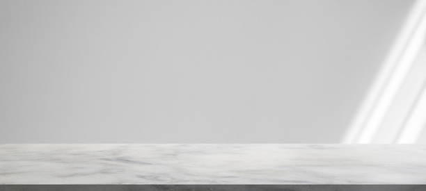 istock Marble table with window shadow drop on white wall background for mockup product display 1343024336
