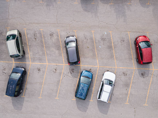 istock Aerial view over parking lot in the rush hour after work in a medium-sized city. Top view, cityscape. 1343024973