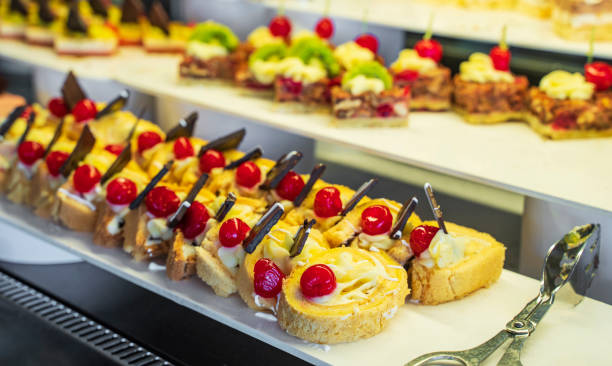 istock Fresh cakes, cake selection, Small chocolate and vanilla layered cakes in rows on candy buffet. Sweet paradise. 1343037695