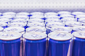 Cans with Energy drink in supermarket. Selective focus.