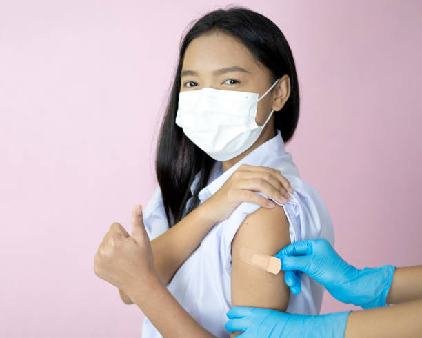 istock Asian student vaccination on pink background. 1343067654