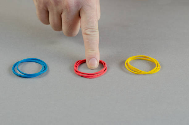 istock The index finger points to the red stationery rubber bands. Thre 1343074496