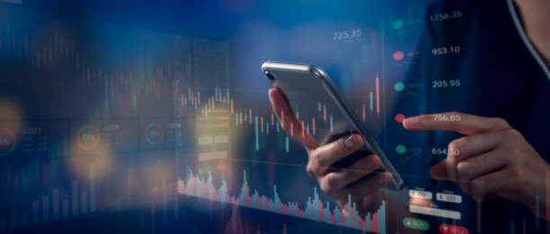 istock Stock exchange market concept, hand using smartphone with graphs analysis candle line on bokeh colors light. 1343076515