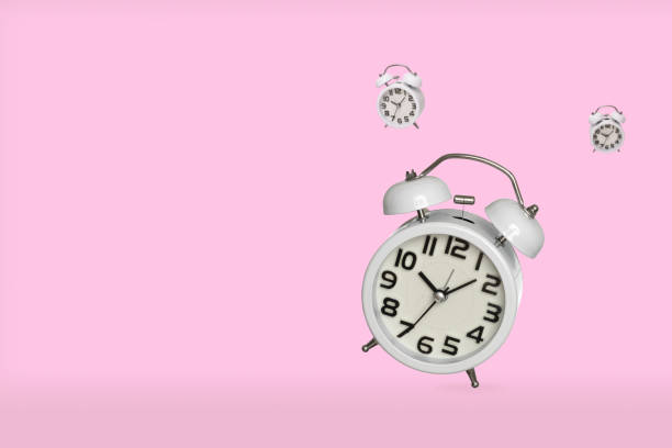 istock Alarm clocks isolated on pink background 1343078415