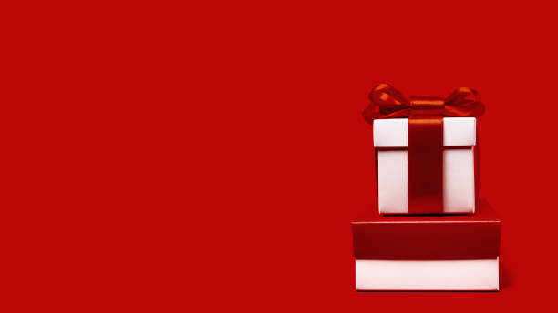 istock One white gift box with reb bow on red background 1343080442