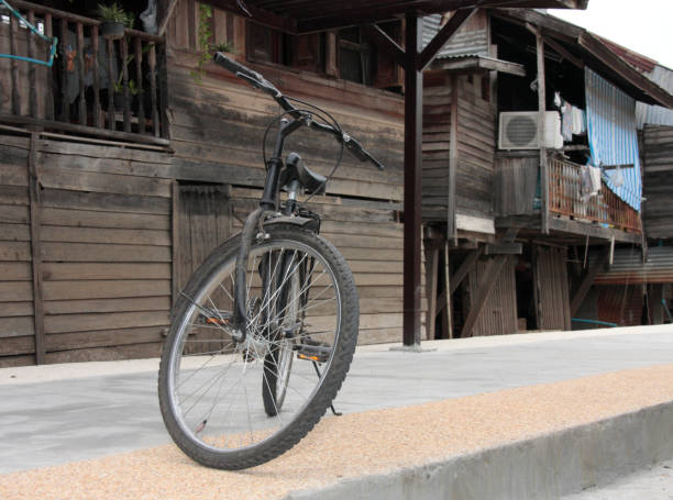 Vintage bicycle in front of the old community in thailand stock photo