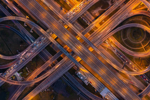 istock Aerial view of highway junctions with roundabout. Bridge roads shape circle in structure of architecture and transportation concept. Top view. Urban city, Bangkok at sunset, Thailand. 1343083478