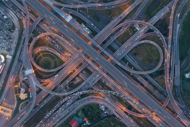 istock Aerial view of highway junctions with roundabout. Bridge roads shape circle in structure of architecture and transportation concept. Top view. Urban city, Bangkok at sunset, Thailand. 1343083481