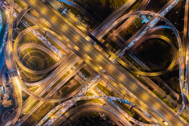 istock Aerial view of highway junctions with roundabout. Bridge roads shape circle in structure of architecture and transportation concept. Top view. Urban city, Bangkok at sunset, Thailand. 1343083489