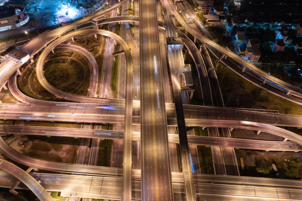 istock Aerial view of highway junctions with roundabout. Bridge roads shape circle in structure of architecture and transportation concept. Top view. Urban city, Bangkok at sunset, Thailand. 1343083758