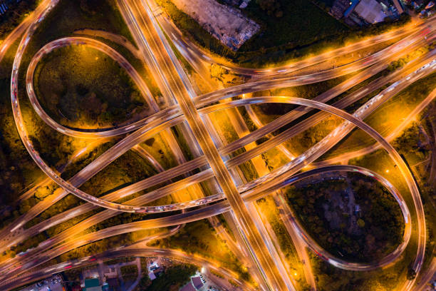 istock Aerial view of highway junctions with roundabout. Bridge roads shape circle in structure of architecture and transportation concept. Top view. Urban city, Bangkok at sunset, Thailand. 1343083792